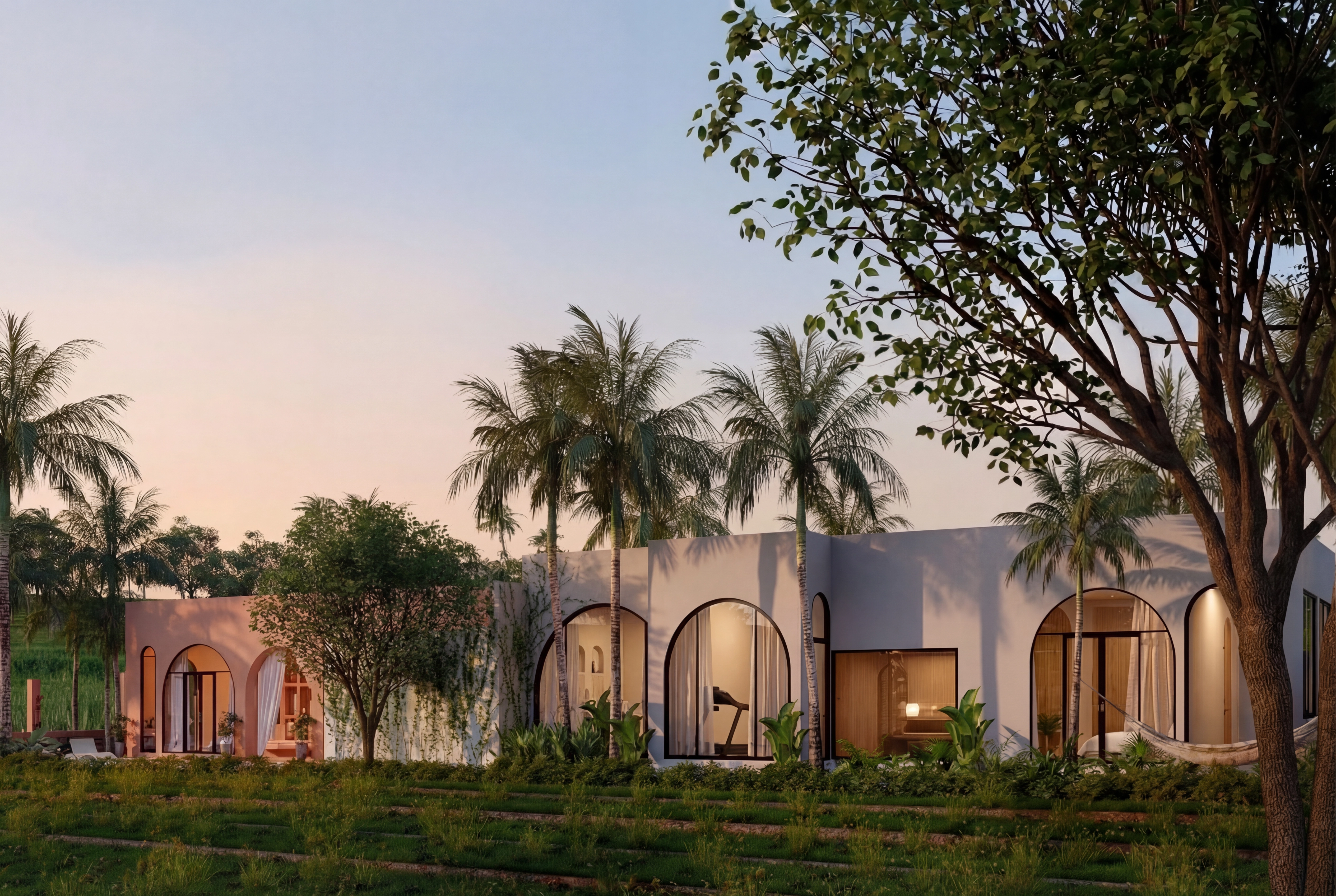 Wide view of the villa facade with glowing arched windows at dusk